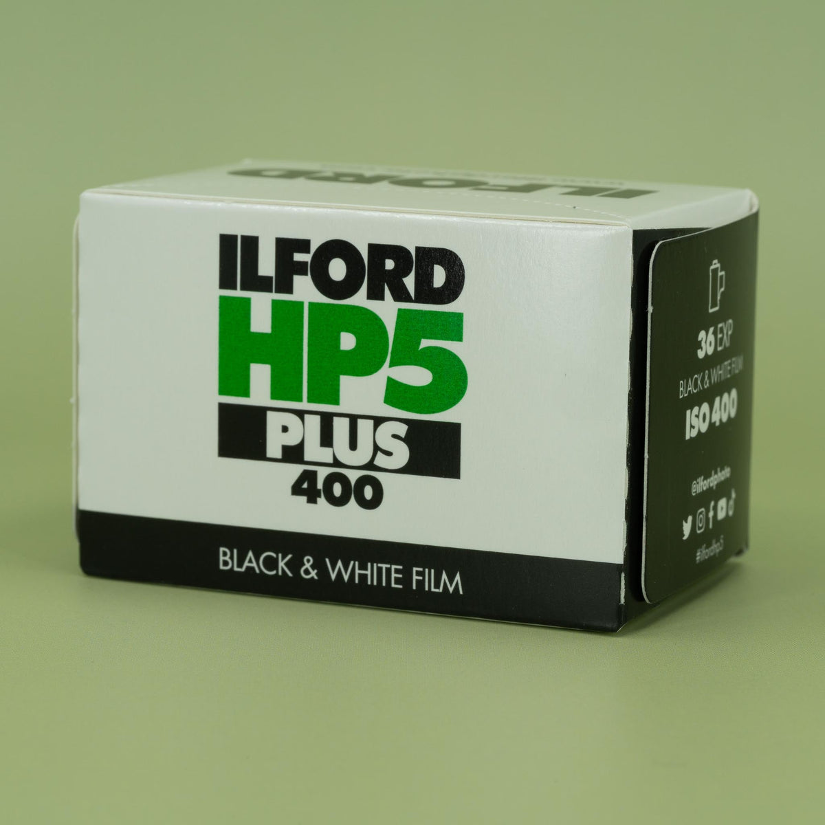 Ilford HP5 Plus 400 black and white 35mm film packaging on a green background