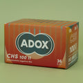 Box of Adox CHS 100 II black & white negative film on a green background