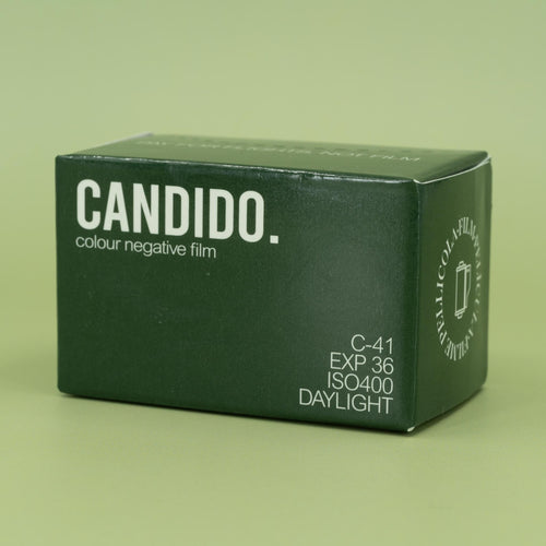 Candido 400 35mm film packaging on a green background
