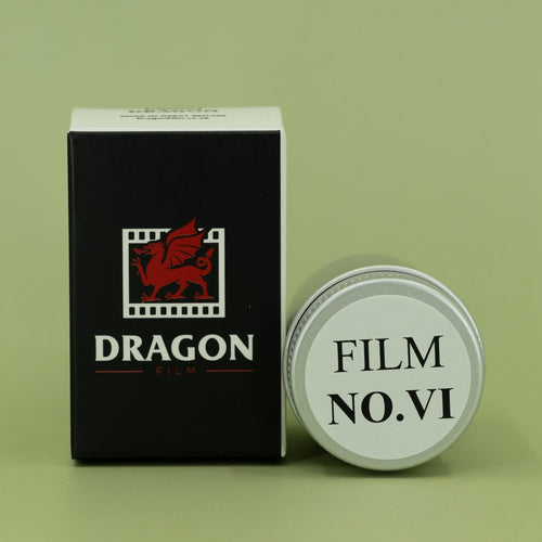 Dragon Film packaging with a cylindrical container on a green background