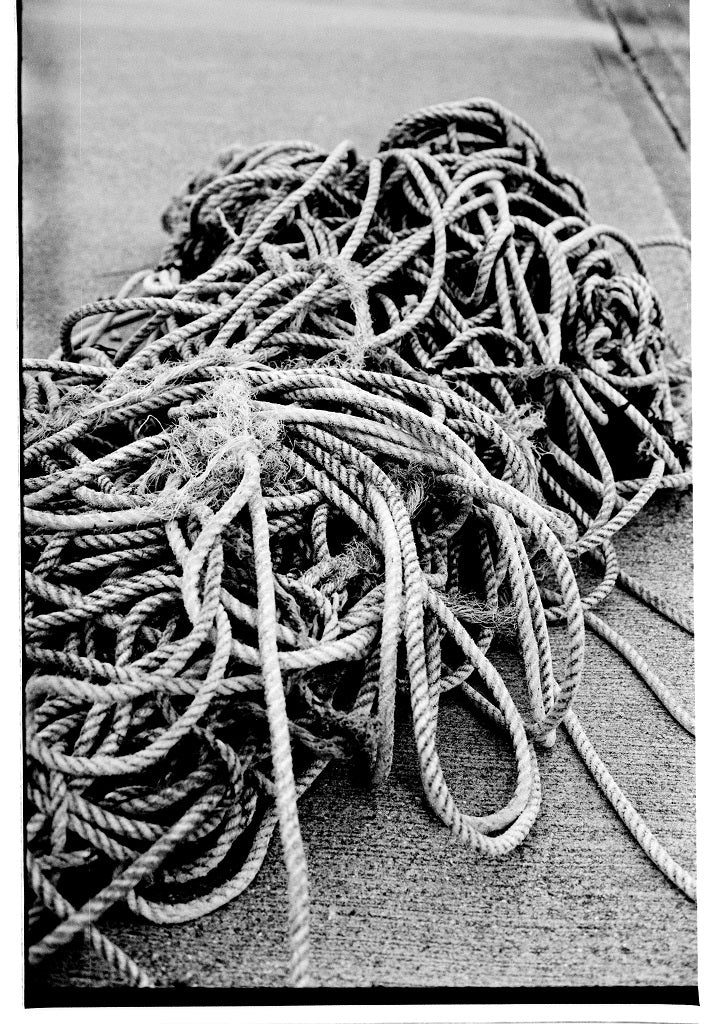 Tangled rope on a concrete surface