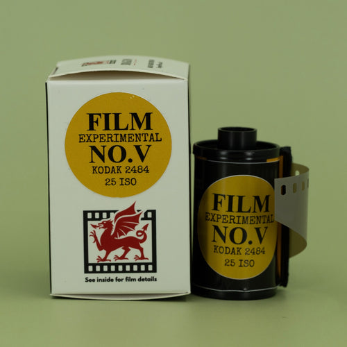 DragonFilm film canister and packaging on a green background