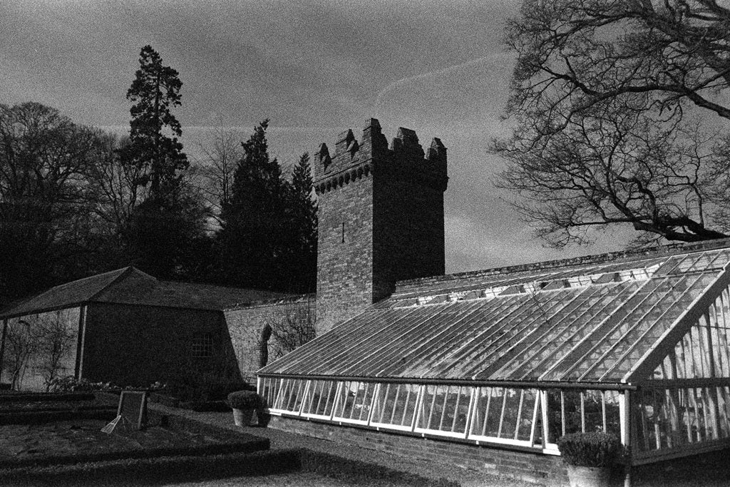 Black and white image of a building with a greenhouse-like structure.