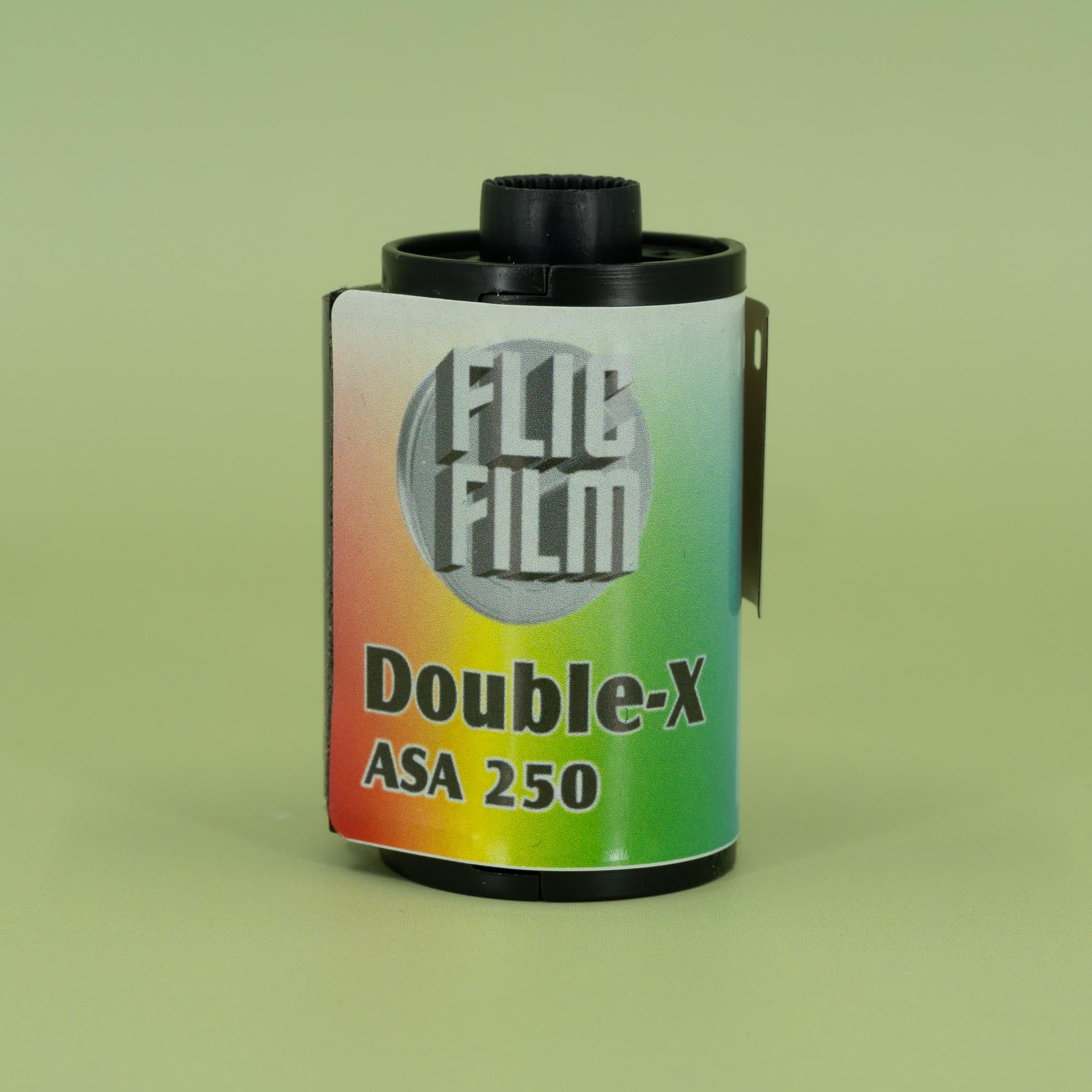 Flic Film Double-X ASA 250' film canister on a green background