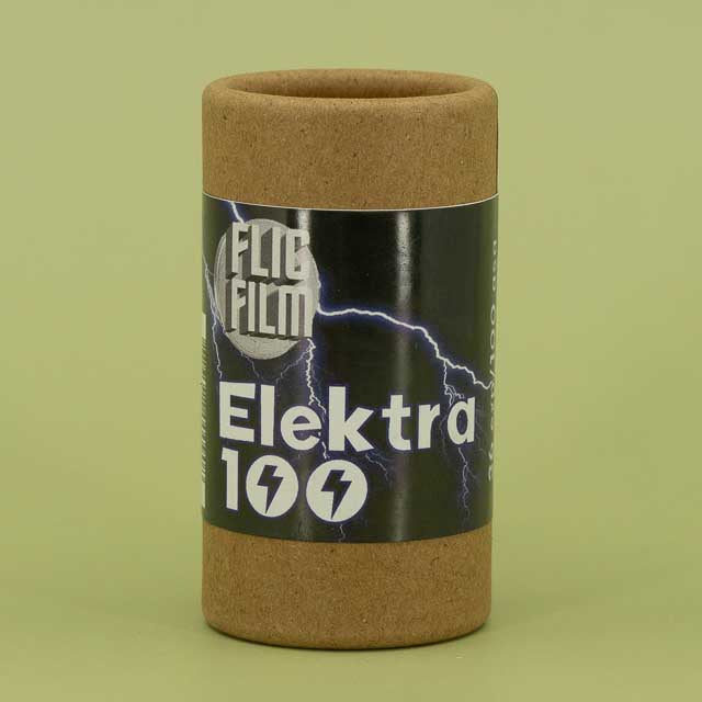 Flic Film Elektra 100 film canister on a green background