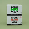 Two Ilford black and white film boxes stacked on a green background