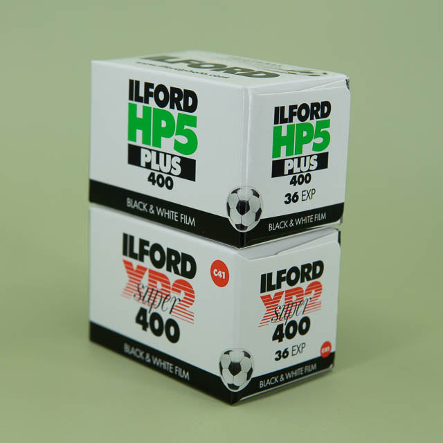 Ilford black and white film boxes on a green background