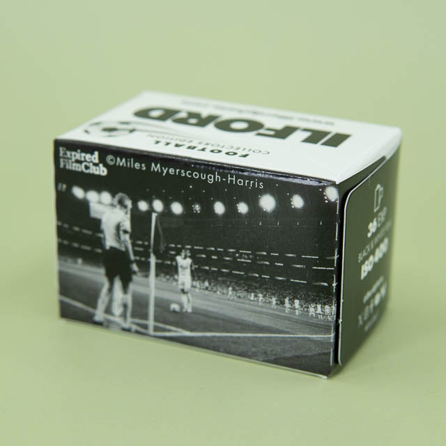 Film canister box with black and white photo and text on a light green background