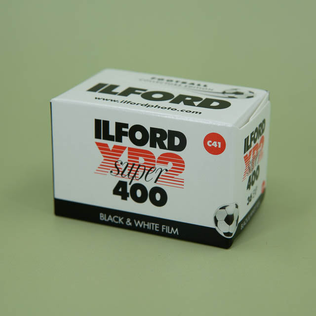 Ilford XP2 Super 400 black and white film box on a green background