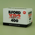 Ilford XP2 Super 400 black and white 35mm film box on a green background