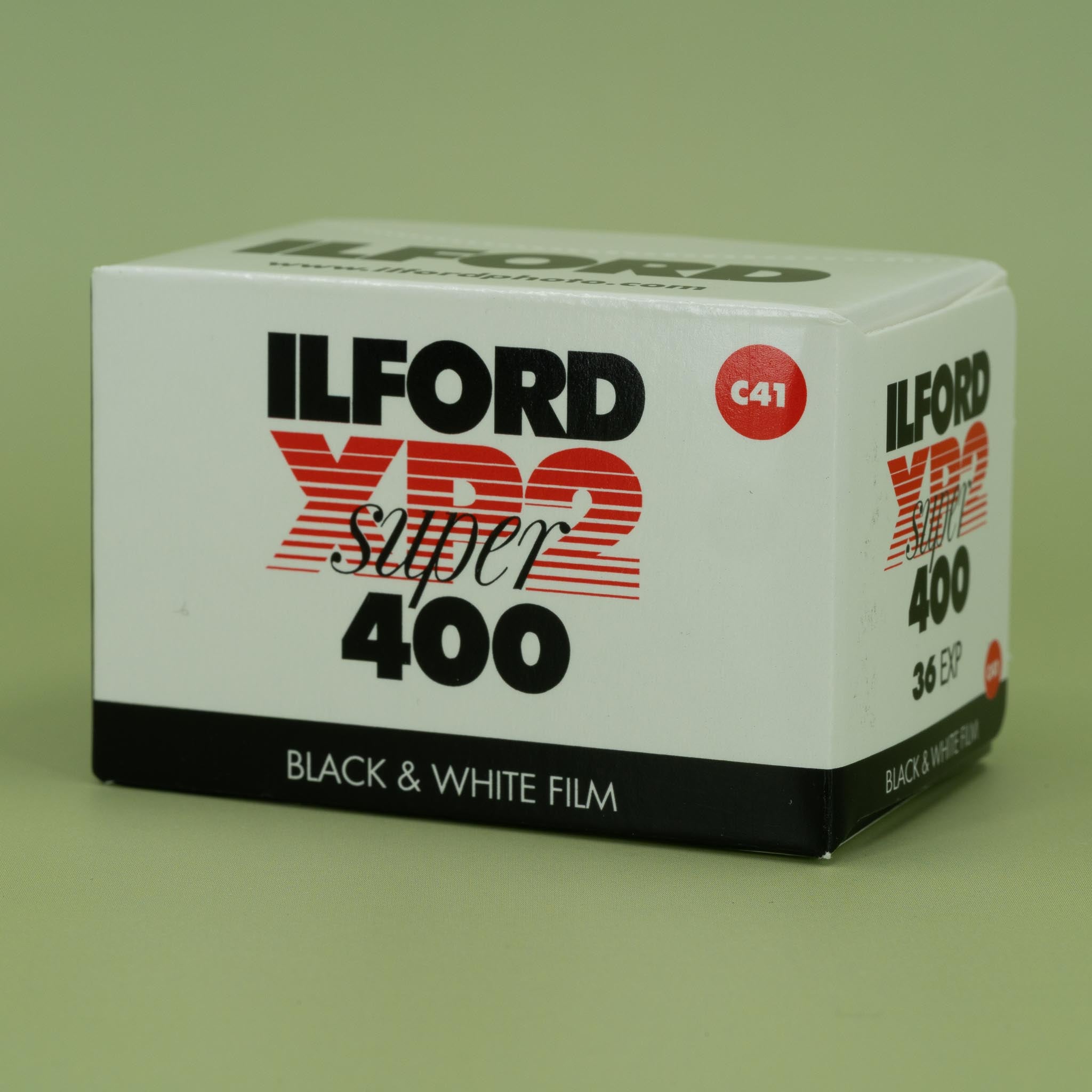 Ilford XP2 Super 400 black and white 35mm film box on a green background