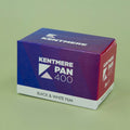 Kentmere Pan 400 black and white film box on a green background