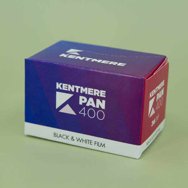 Kentmere Pan 400 black and white film box on a green background