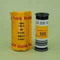 Kodak 200 Gold 120 film canister on a green background