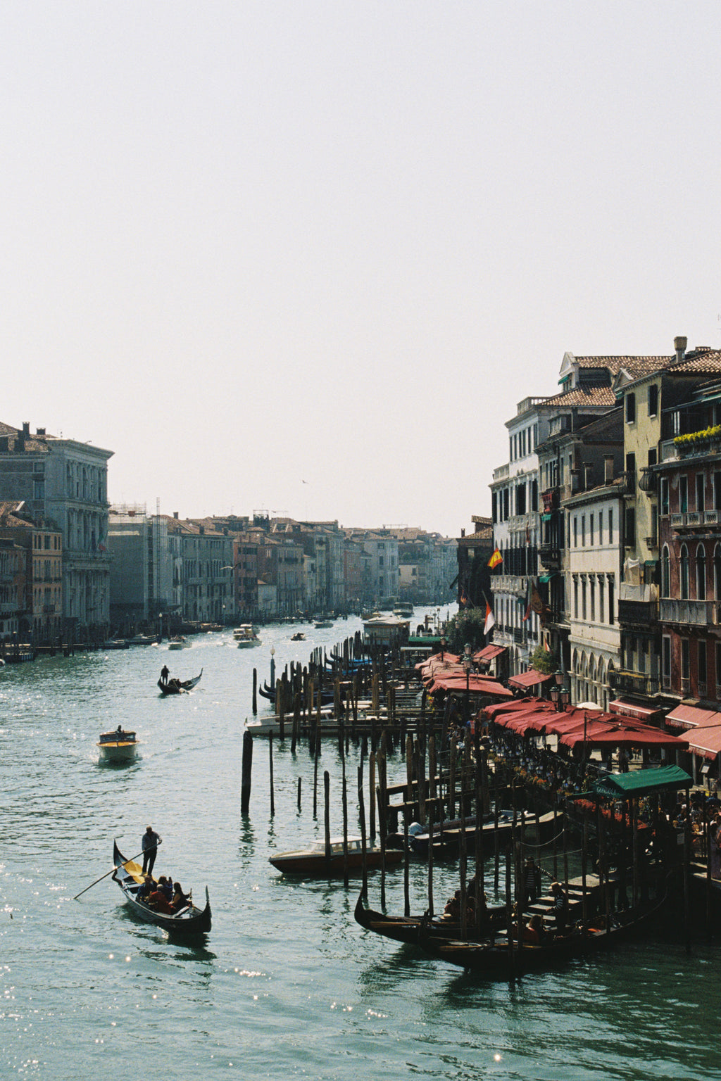 Venetian canal with gondolas and buildings reflected in the water