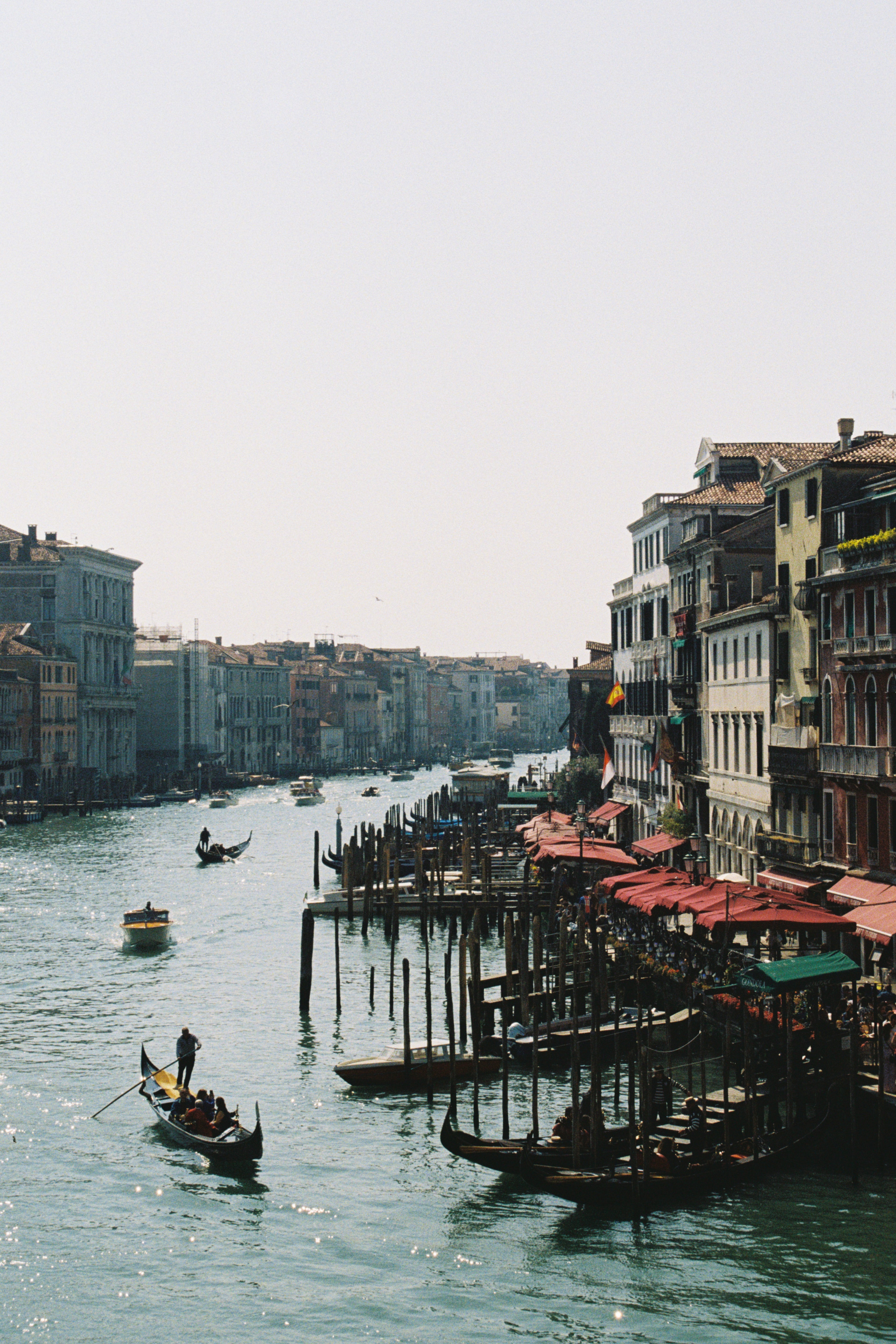 Venetian canal with gondolas and buildings reflected in the water
