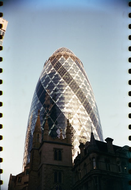 Modern skyscraper with unique geometric design against a clear blue sky