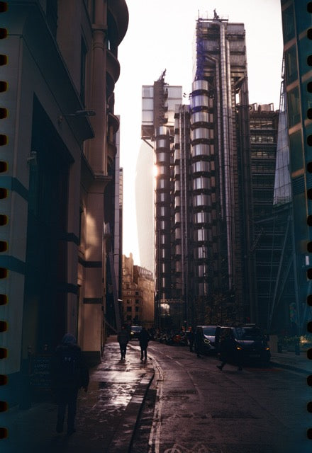 City street with modern buildings and people walking in London