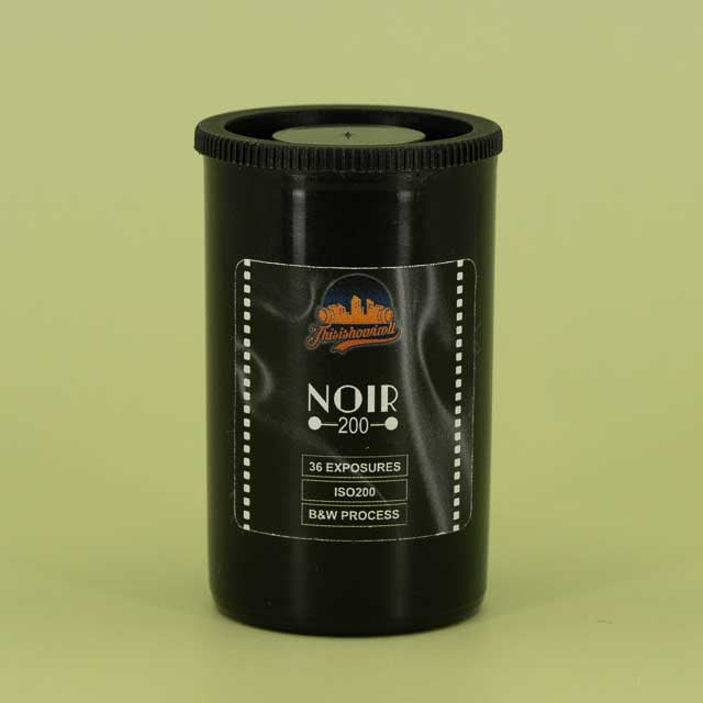 This is how I roll Noir 200 film canister on a green background