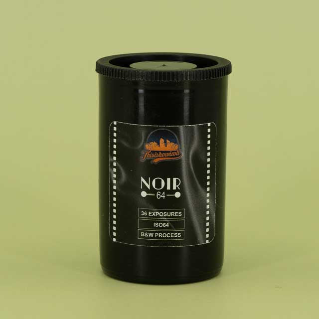 This is how I roll Noir 64 film canister on a green background